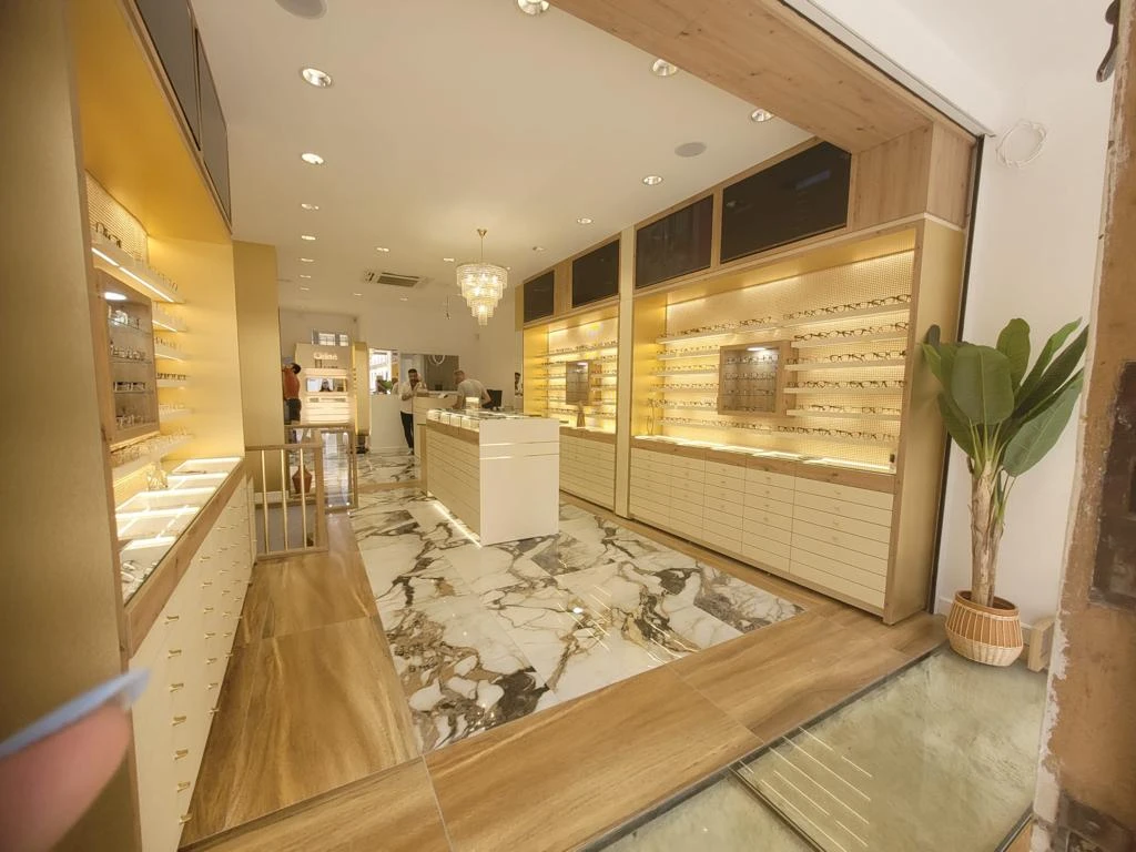 Boutique d'optique premium - Sol en marbre, éclairage LED et menuiserie bois luxe - BATINOVA